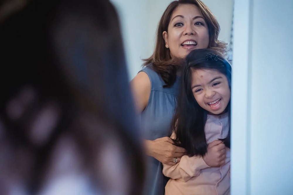 Mother and Daughter Looking at the Mirror Together