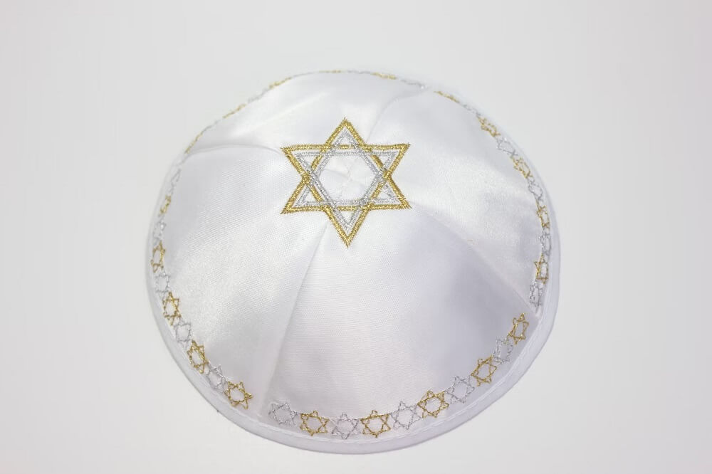 a white hat with a gold star of david on it 